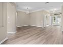 Spacious living room with wood floors, crown molding, and a view of the front door at 11045 Belmere Isles Ct, Windermere, FL 34786