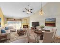 Bright living room with vaulted ceiling, fireplace, and dining area at 4621 N Pine Hills Rd # 113, Orlando, FL 32808