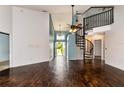 Bright living room with high ceilings, spiral staircase, wood-look flooring, and plenty of natural light at 10557 Glassborough Dr, Orlando, FL 32825