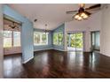 Spacious living area showcasing wood-look floors and a seamless flow to the outdoor patio area at 10557 Glassborough Dr, Orlando, FL 32825