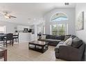 Spacious living room with vaulted ceiling, large windows, and tiled flooring for easy maintenance at 246 Kimberly Point Dr, Davenport, FL 33837