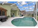 Inviting screened-in pool area with a covered lanai and seating, perfect for relaxation at 246 Kimberly Point Dr, Davenport, FL 33837