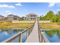 Scenic view of the backyard and dock on the lake, offering a private escape and waterfront living at 13016 Shady Retreat Loop, Clermont, FL 34711