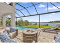 Relaxing pool area with fire pit and lake view at 13016 Shady Retreat Loop, Clermont, FL 34711