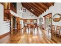 Bright living room with wood floors, spiral staircase, wood beam ceiling and open access to the outside at 2459 Adelia Blvd, Deltona, FL 32725