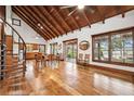 Open-concept living room boasts hardwood floors, high ceilings, and spiral staircase to the second floor at 2459 Adelia Blvd, Deltona, FL 32725