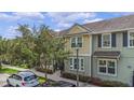 Attractive townhome showcasing a colorful facade, neat landscaping, and convenient parking, offering comfortable living at 1349 Mill Stream Ln, Winter Springs, FL 32708