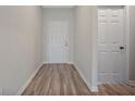 Bright entryway with wood-look flooring and white doors at 3544 Forster Ave, Leesburg, FL 34748