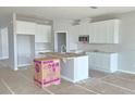 Modern kitchen features white cabinets and an island at 2619 Great Heron Ave, Saint Cloud, FL 34771