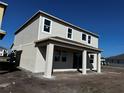 New two-story home featuring neutral siding, bright windows, and a covered patio perfect for outdoor enjoyment at 2655 Great Heron Ave, Saint Cloud, FL 34773