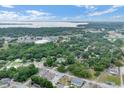 Expansive aerial view showcases the neighborhood, nearby lake, and lush greenery at 500 N 13Th St, Leesburg, FL 34748