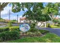 Community sign for Kiawah Bay surrounded by lush landscaping and mature trees at 740 #3 Killarney Bay Ct # 7-3, Winter Park, FL 32789