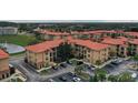 Community aerial view showing terracotta roofs, ample parking, and beautiful landscaping at 907 Charo Pkwy # 923, Davenport, FL 33897