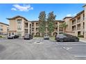 Apartment building showcasing its architecture, parking spaces, and landscaping at 907 Charo Pkwy # 923, Davenport, FL 33897