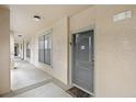 Hallway with apartment door and window view outside of the apartment at 907 Charo Pkwy # 923, Davenport, FL 33897