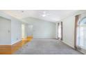Bright living room with vaulted ceilings, a ceiling fan, and hardwood floors at 5825 Princess Caroline Pl, Leesburg, FL 34748