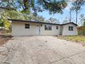 Newly renovated house with a large front yard and driveway at 1111 N Hart Blvd, Orlando, FL 32818