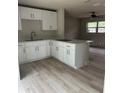 Modern kitchen featuring white shaker cabinets and quartz countertops at 1111 N Hart Blvd, Orlando, FL 32818