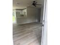 Bright and airy living room with wood-look vinyl flooring at 1111 N Hart Blvd, Orlando, FL 32818