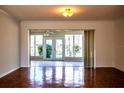 Living room with parquet flooring and view of a sunroom at 4423 Real Ct, Orlando, FL 32808