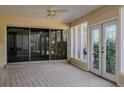 Sunroom with tiled floors, sliding glass doors, and ceiling fan at 4423 Real Ct, Orlando, FL 32808