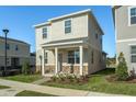 Two-story house with light beige siding, stone accents, and a covered porch at 5554 Stockade Blvd, Saint Cloud, FL 34771