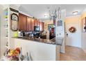 Modern kitchen with granite countertops and dark wood cabinets at 906 Charo Pkwy # 433, Davenport, FL 33897