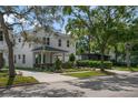 Charming two-story home with landscaped yard, portico, and driveway at 1020 W Princeton St, Orlando, FL 32804