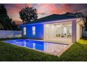 Backyard with a modern pool and a covered patio, perfect for relaxation and entertainment at 1020 W Princeton St, Orlando, FL 32804