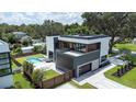 Aerial view showcasing the modern home with a backyard pool, patio, and lush landscaping at 2522 Lafayette Ave, Winter Park, FL 32789