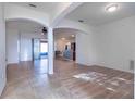 Bright living room featuring a combination of tile and wood floors and lots of natural light from a sliding glass door at 176 Blackstone Creek Rd, Groveland, FL 34736