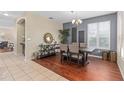 Open dining room boasts hardwood floors, stylish decor, and modern chandelier, perfect for Gathering gatherings at 226 W Tarrington Dr, Deland, FL 32724
