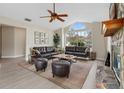 Bright living room featuring vaulted ceilings, a fireplace and large windows providing lots of natural light at 304 Hibiscus St, Chuluota, FL 32766