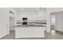 Modern kitchen features an island, granite countertops, and stainless steel appliances at 2676 Hancock Crossing Dr, Bartow, FL 33830