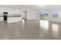 Open concept living room/kitchen with lots of natural light and tile floors at 2676 Hancock Crossing Dr, Bartow, FL 33830