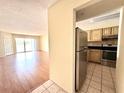 Open-concept living room leading to the kitchen with stainless steel appliances at 13803 Fairway Island Dr # 1627, Orlando, FL 32837