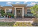 Welcoming front porch with brick pavers and decorative plants at 290 Thomas Dr, Casselberry, FL 32707