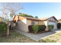 Well-maintained home with lush landscaping, a two-car garage, and a cozy front porch at 666 Sausalito Blvd, Casselberry, FL 32707