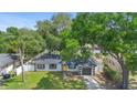 Charming one-story house boasting a well-kept lawn and a striking yellow entrance door at 3703 Pembrook Dr, Orlando, FL 32810