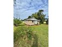 Charming bungalow with landscaped lawn and light blue door at 620 Oak St, Auburndale, FL 33823