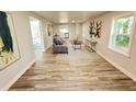 Open concept living space with gray couch and wood-look floors at 620 Oak St, Auburndale, FL 33823