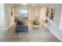 Open living room, hardwood floors, view into kitchen at 620 Oak St, Auburndale, FL 33823