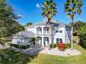 Well-manicured lawn and vibrant foliage complement this home's stately architecture and inviting entrance at 10542 Wittenberg Way, Orlando, FL 32832