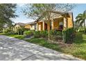 Charming home with a landscaped front yard, inviting curb appeal, and a covered front porch at 14132 Murcott Blossom Blvd, Winter Garden, FL 34787