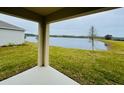 Covered patio overlooking a serene lake at 1208 Big Bass Dr, Ormond Beach, FL 32174