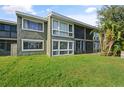 Exterior of the home showcasing a well-maintained lawn and screened patio area with a view to the side at 5783 Peregrine Ave # C07, Orlando, FL 32819