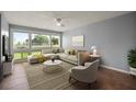 Bright living room with large windows, comfortable seating, and a stylish rug, perfect for relaxation at 5783 Peregrine Ave # C07, Orlando, FL 32819