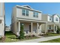 Two-story house with light beige siding, stone accents, and a covered porch at 344 Belmond Dr, Debary, FL 32713