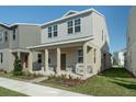 Two-story house with light beige siding, stone accents, and a covered porch at 344 Belmond Dr, Debary, FL 32713