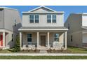 Two-story house with light beige siding, stone accents, and a covered porch at 344 Belmond Dr, Debary, FL 32713